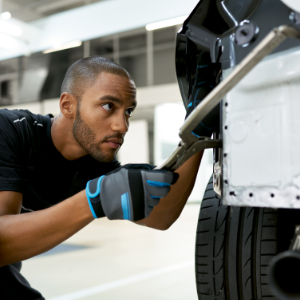 BMW Trained Technician performs bonding and riveting repair on a BMW vehicle in a BMW Certified Collision Repair Center.